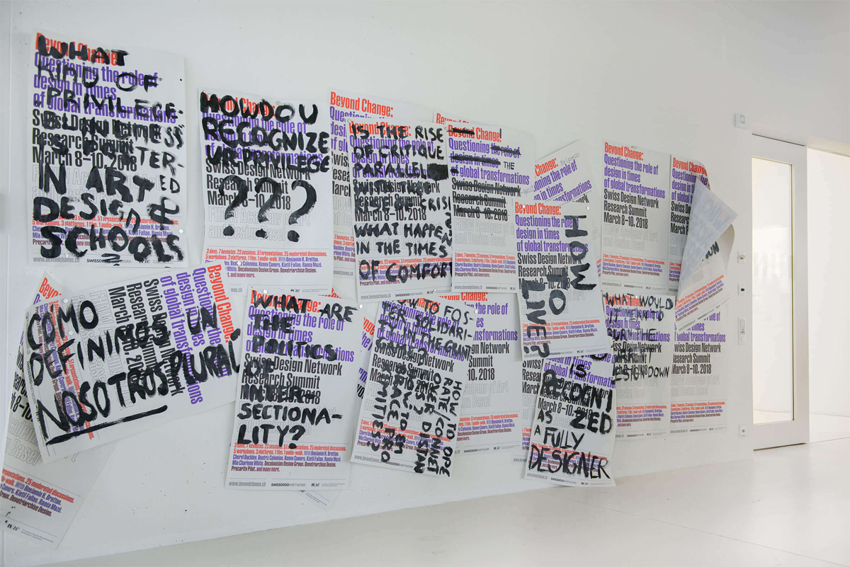 Posters at the Beyond Change Conference are re-worked with handwritten notes such as "how do you recognise your privilege?"